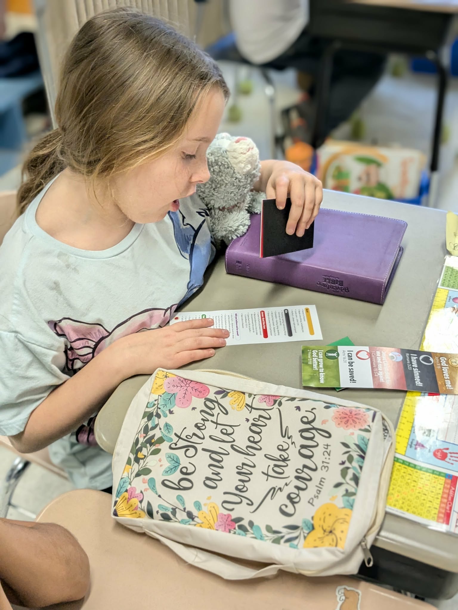 Students sharing a book in the PBCS library